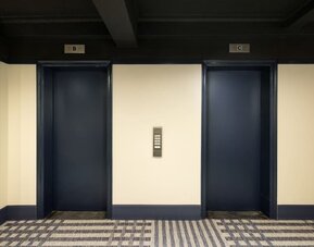Elevator lobby with dark modern accents and contemporary design elements at Row NYC.
