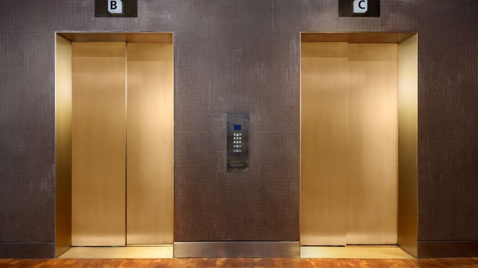 Contemporary elevator area with metallic finishes and upscale urban design at Row NYC.