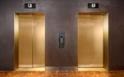 Contemporary elevator area with metallic finishes and upscale urban design at Row NYC.
