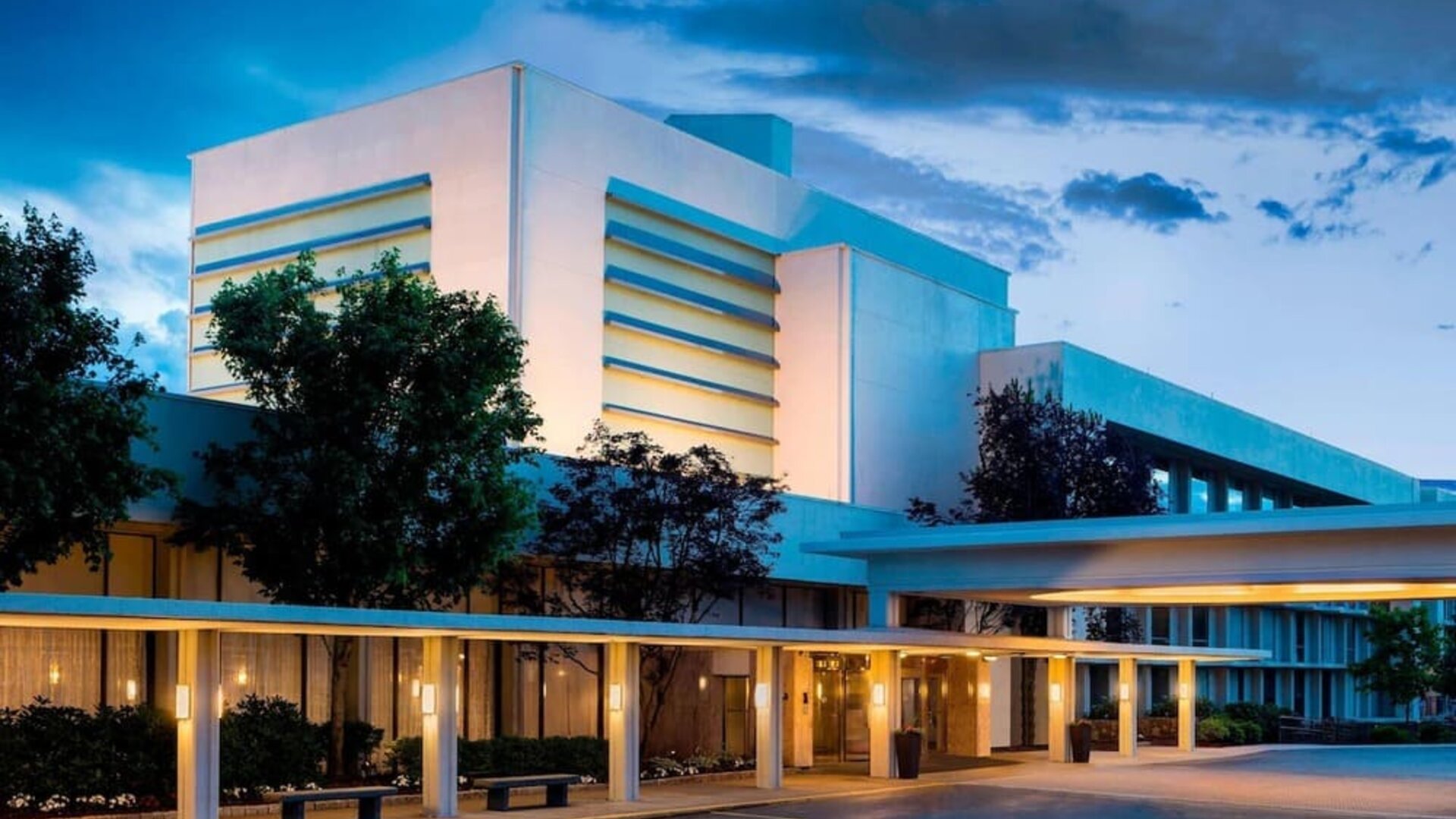 Exterior view of Boston Marriott Newton showcasing contemporary architecture and welcoming covered entrance.