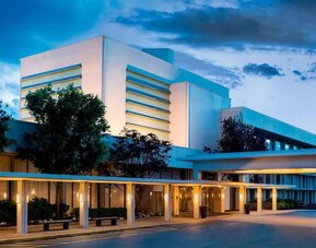 Exterior view of Boston Marriott Newton showcasing contemporary architecture and welcoming covered entrance.
