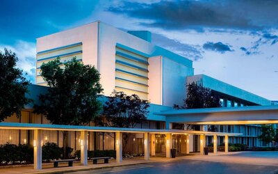 Exterior view of Boston Marriott Newton showcasing contemporary architecture and welcoming covered entrance.
