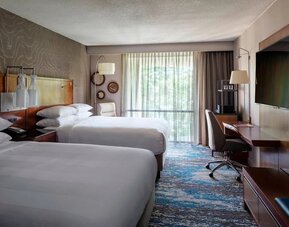 Contemporary double guest room with two comfortable beds, workspace, and large window views at Boston Marriott Newton.