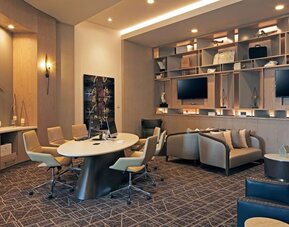 Business center with computers, printer and ergonomic seating at H Hotel Los Angeles, Curio Collection By Hilton.