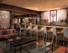 Sophisticated hotel bar featuring handcrafted décor, comfortable seating, and a full-service beverage area at The Garland.