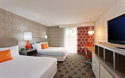 Modern double-bed guest room offering comfortable accommodations, workspace amenities, and contemporary décor at The Garland.