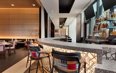 Stylish hotel bar and restaurant space offering contemporary décor, comfortable seating, and a vibrant setting for dining or evening drinks.