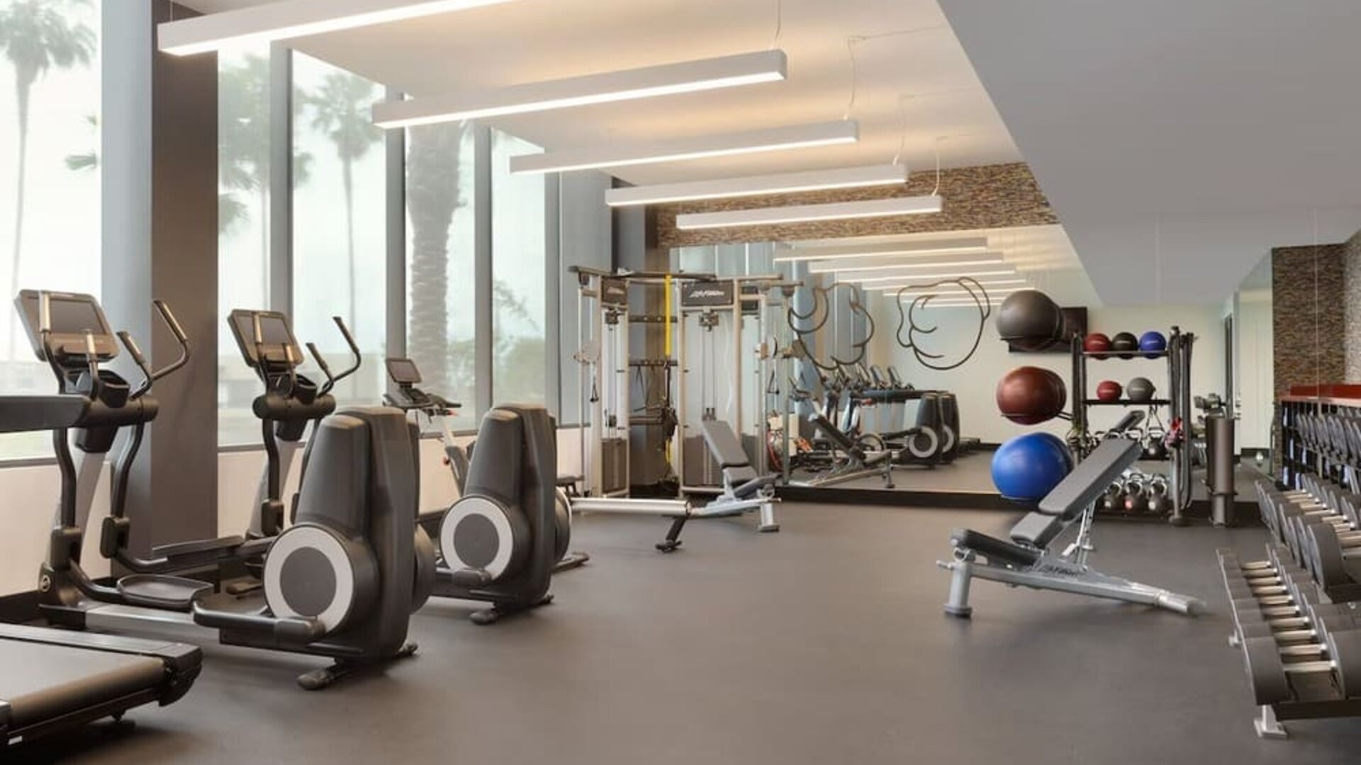 Fully equipped fitness center offering cardio machines, free weights, and strength-training equipment for guests maintaining their workout routines.