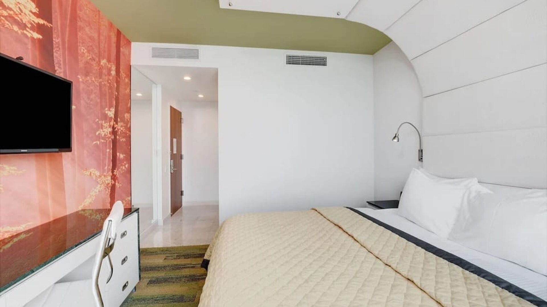 Stylish king bedroom with contemporary décor, plush bedding, work desk, flat-screen television, and thoughtfully designed interior finishes.