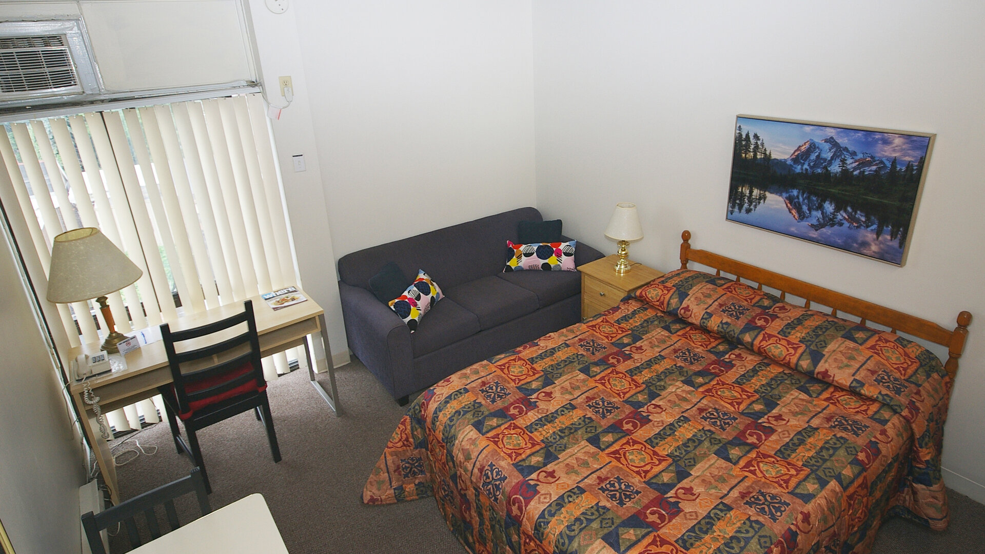 Standard day use room with sofa and work desk at Alexandra Hotel.