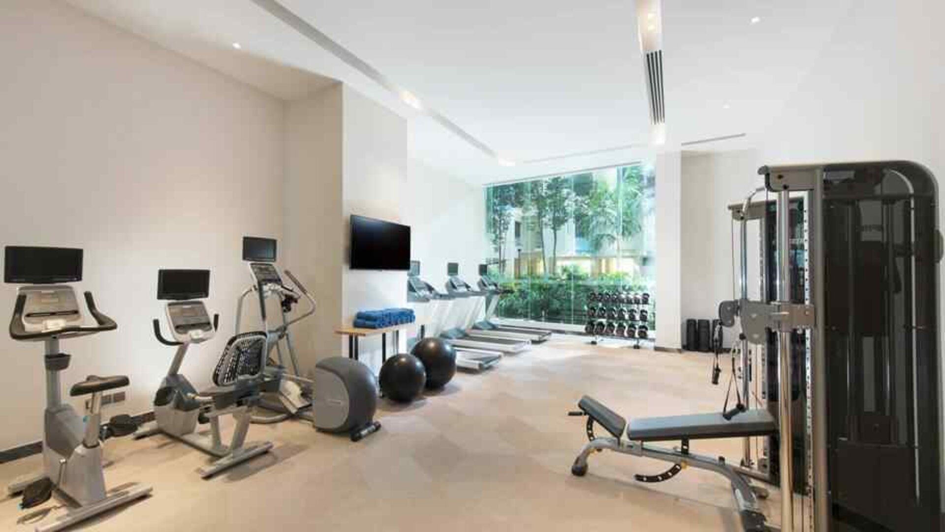 Fully equipped fitness center with treadmills and weights at the Hilton Garden Inn Singapore Serangoon.