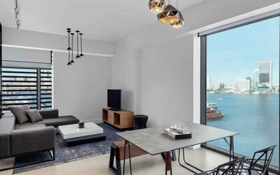 Oversized king suite with living room and superb creek view at the Canopy by Hilton Dubai Al Seef.