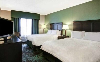 Day use twin room with TV, work desk and window view at the Hampton Inn by Hilton Toronto Airport Corporate Centre.