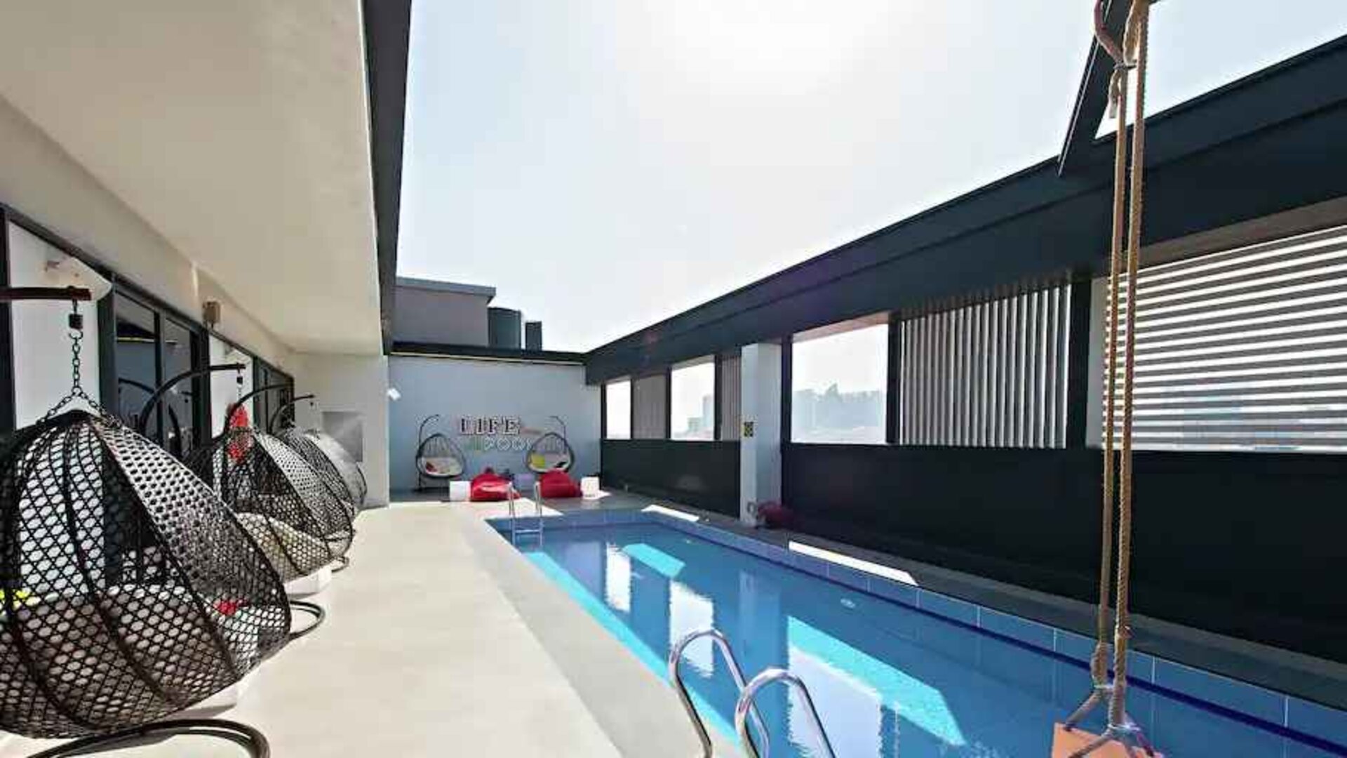 Relaxing rooftop with pool at the Hampton by Hilton Dubai Al Seef.