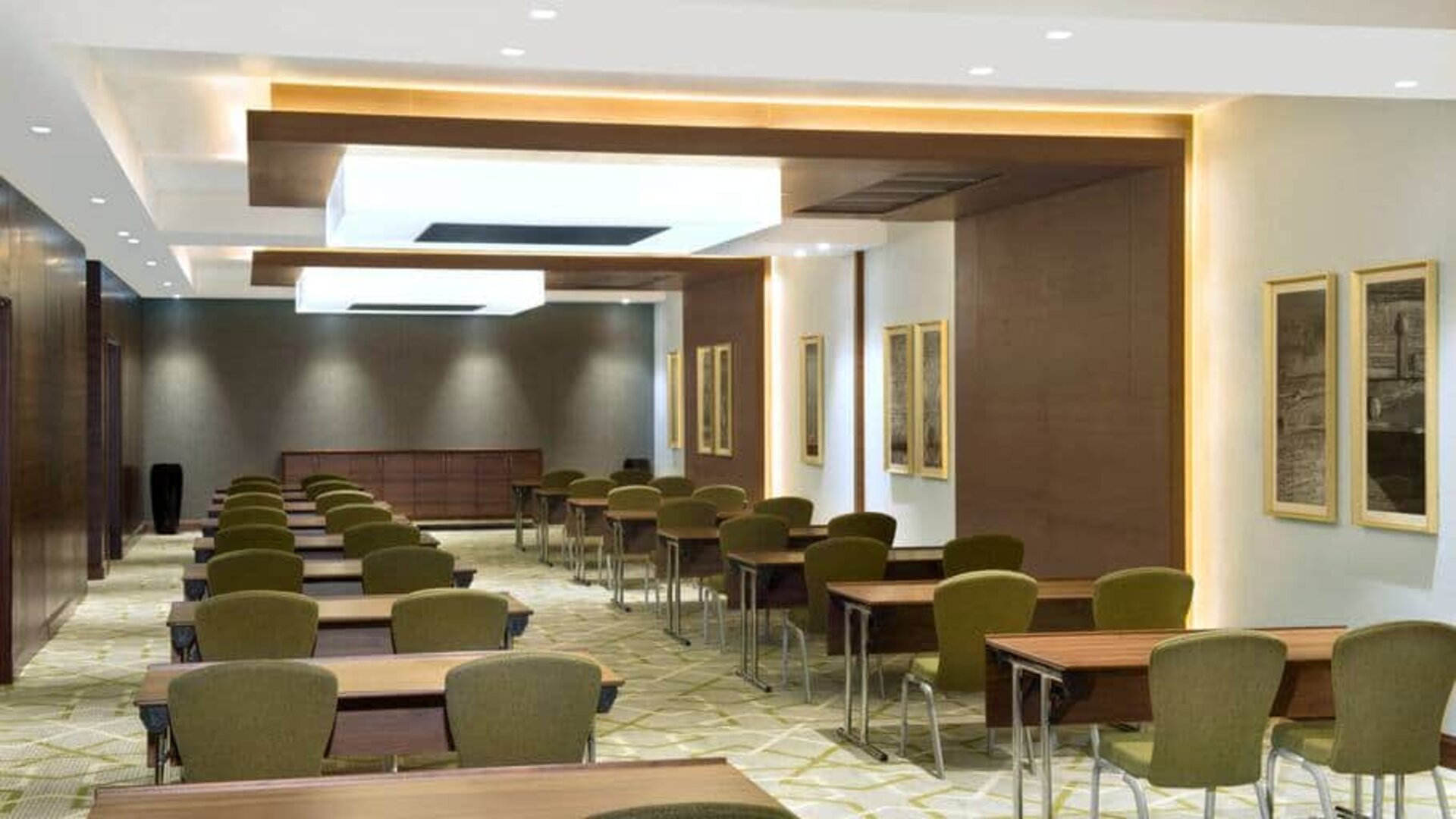 Large meeting room and workspace with multiple chairs and desks at the Hilton Garden Inn Dubai Al Muraqabat