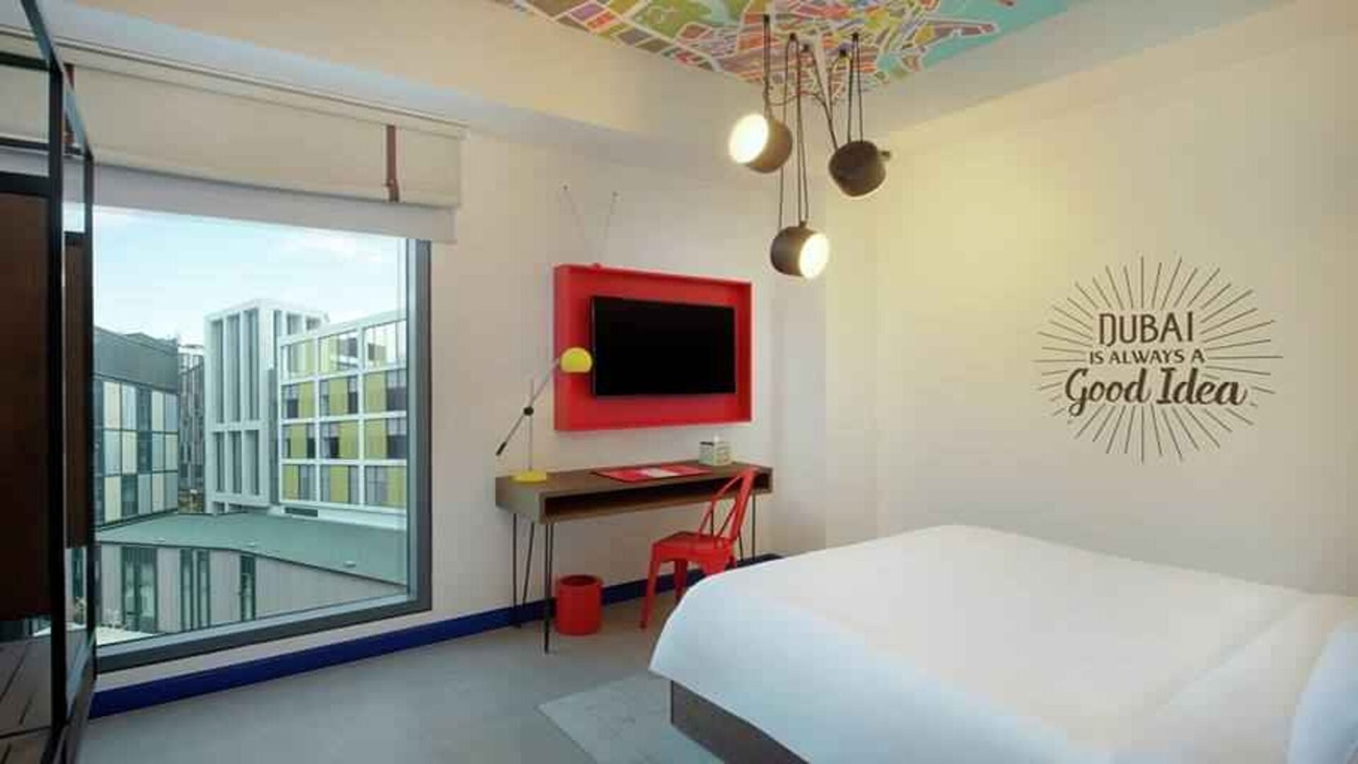 Comfortable room with window and TV screen at the Hampton by Hilton Dubai Al Seef.