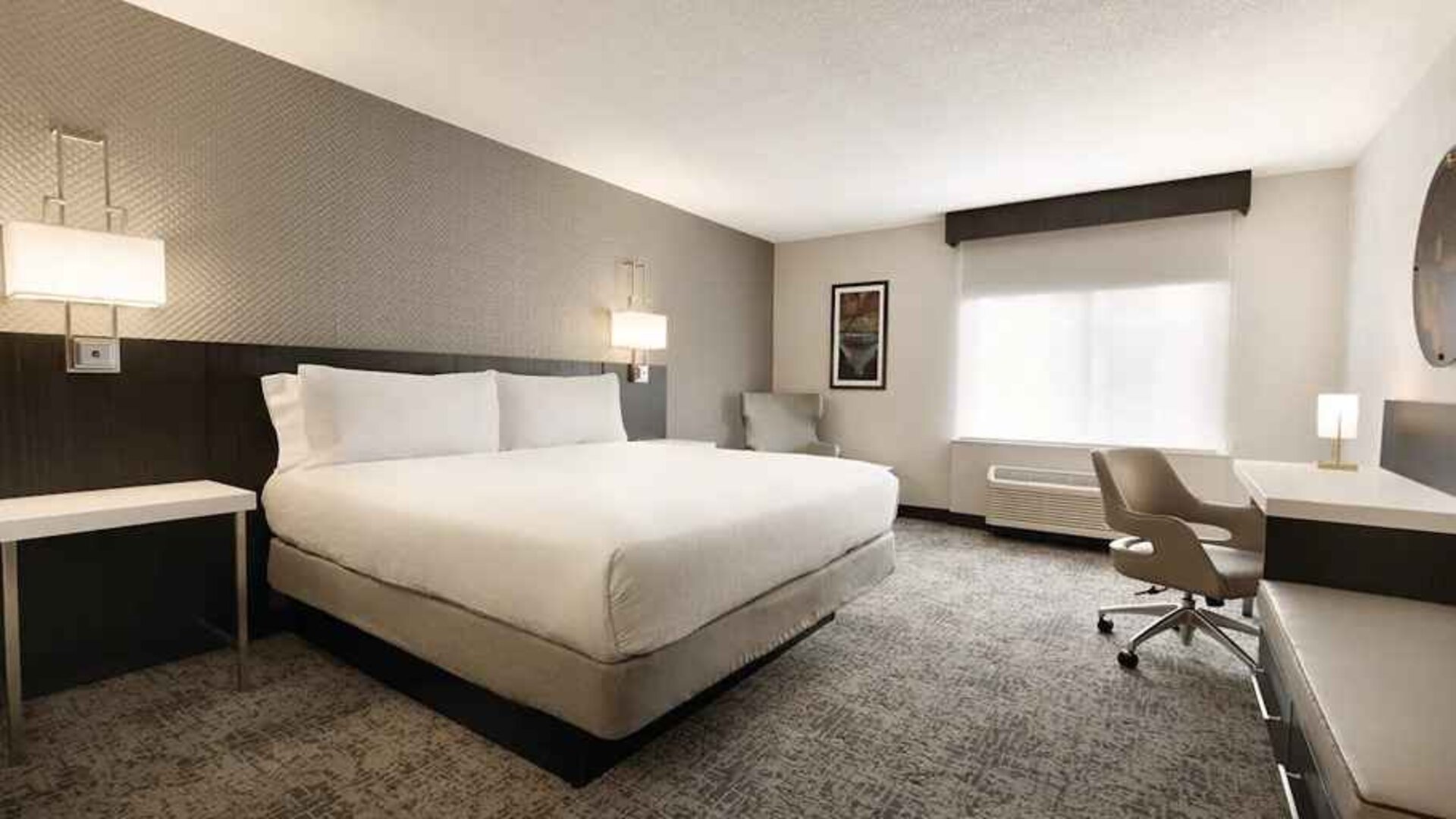 Cozy king bedroom with work desk at Hilton Garden Inn Washington DC Downtown.