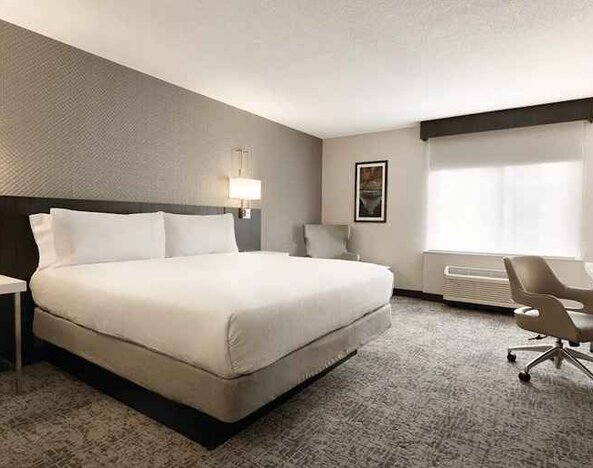 Cozy king bedroom with work desk at Hilton Garden Inn Washington DC Downtown.