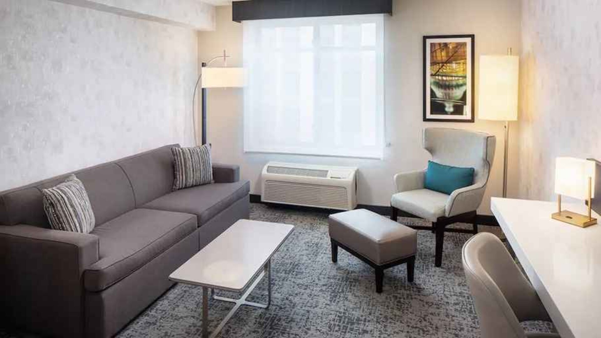 Bright-lit living area inside day use room at Hilton Garden Inn Washington DC Downtown.