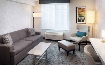 Bright-lit living area inside day use room at Hilton Garden Inn Washington DC Downtown.
