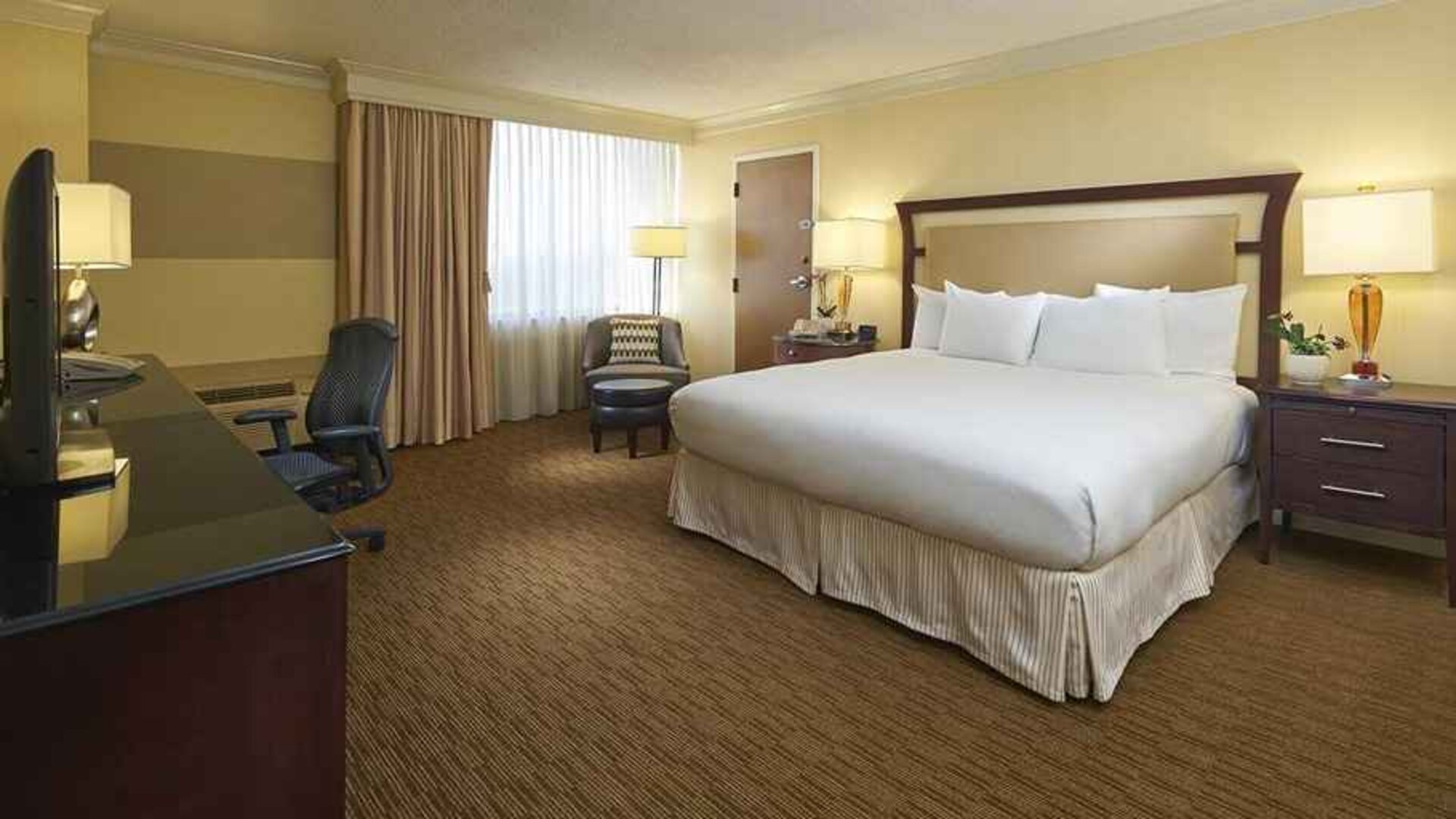 spacious king room equipped with work desk and natural light at Hilton Raleigh North Hills.