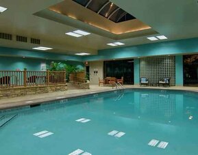 large outdoor pool with seating area at Hilton Raleigh North Hills.