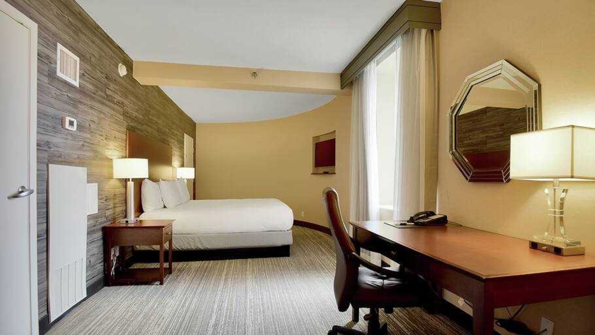 Desk and king size bed in a hotel room at the DoubleTree Suites by Hilton Houston by the Galleria.