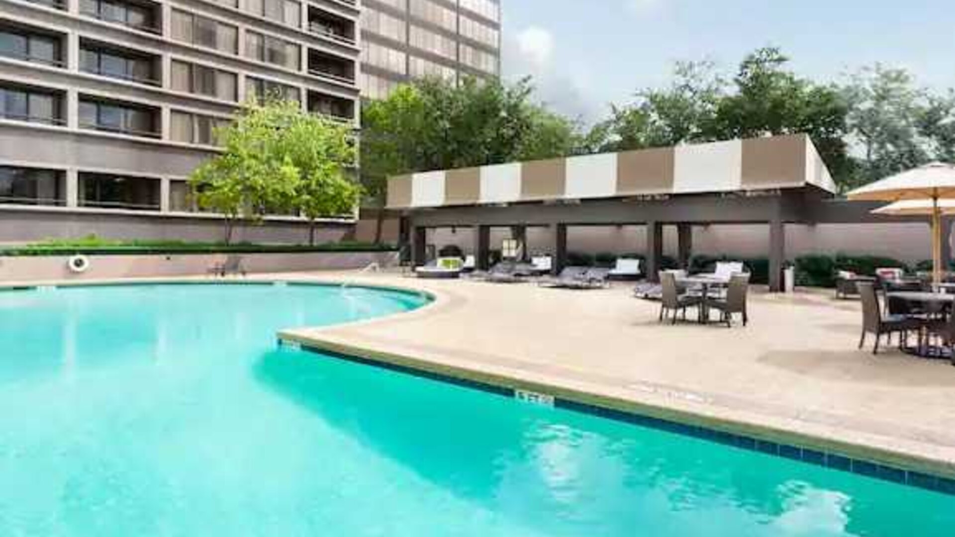 Relaxing outdoor pool area at the DoubleTree Suites by Hilton Houston by the Galleria.