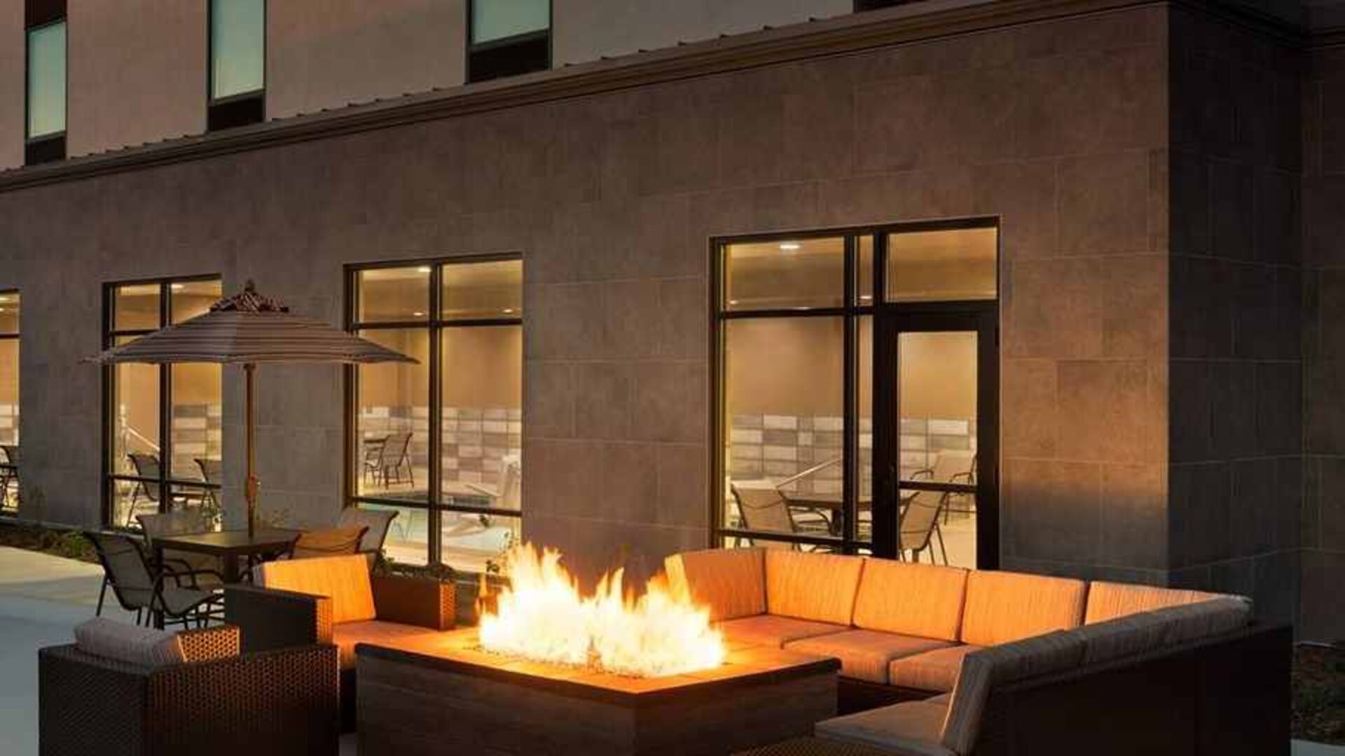 Beautiful outdoor patio with comfortable seating and coworking space at Hampton Inn By Hilton, Salt Lake City Cottonwood.