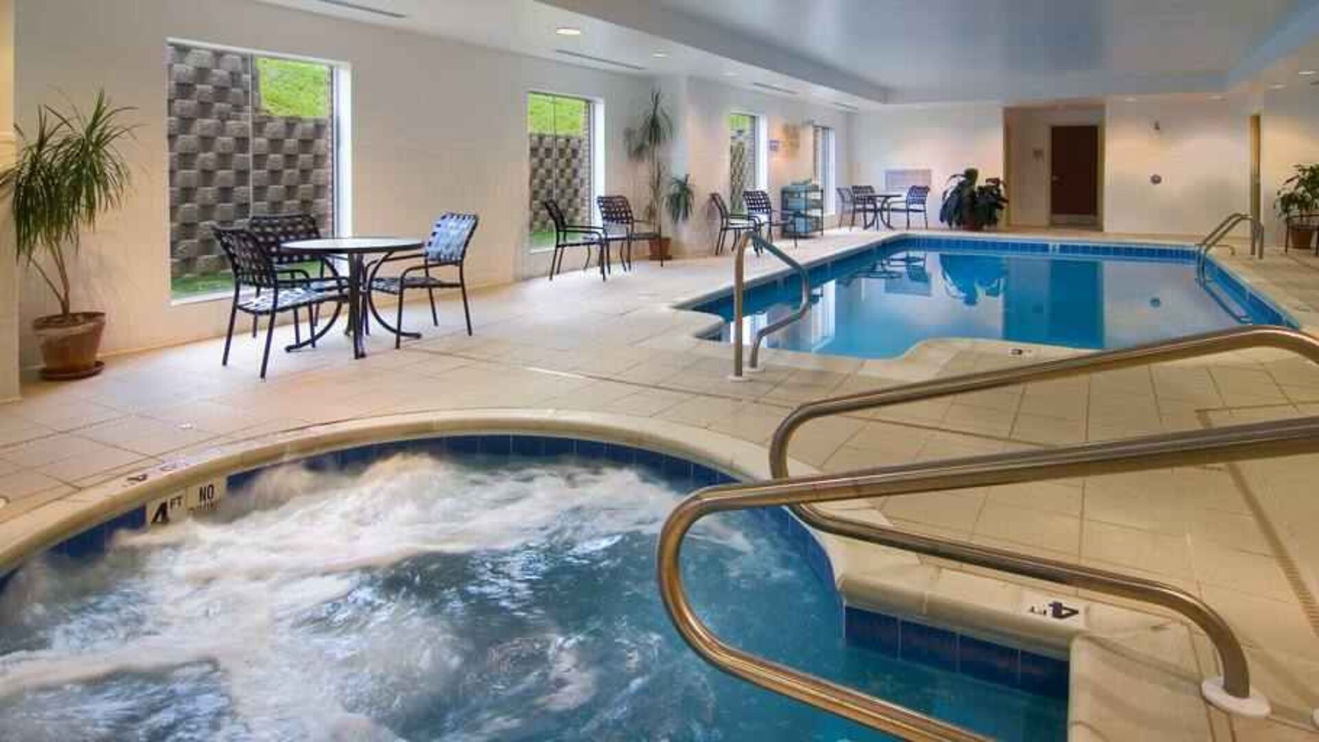 Relaxing indoor pool area with whirlpool at the Hilton Garden Inn Clarksburg.