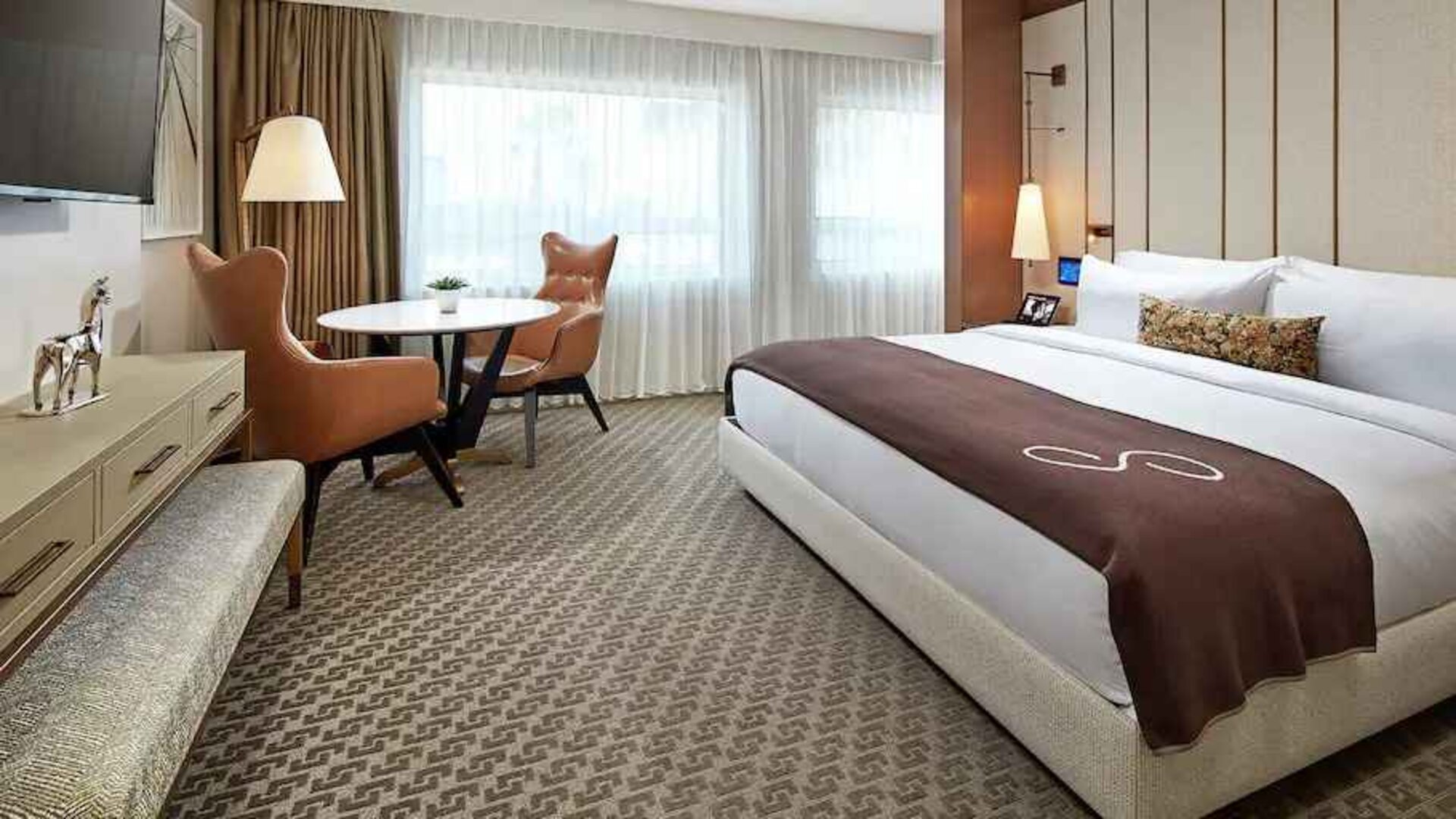 Comfortable king deluxe room with desk and window at the Statler Dallas, Curio Collection by Hilton.