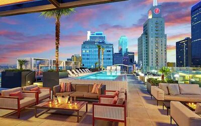 Stunning rooftop with pool and seating area perfect as workspace at the Statler Dallas, Curio Collection by Hilton.