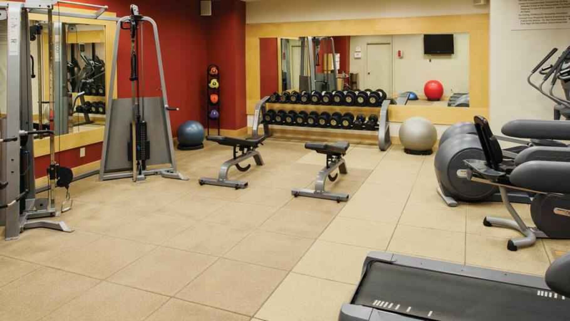 Fitness center with weights and machines at the DoubleTree by Hilton Omaha-Downtown.