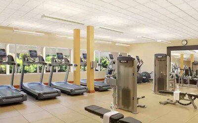 Fitness center with treadmills and machines at the Hilton Seattle Airport & Conference Center.