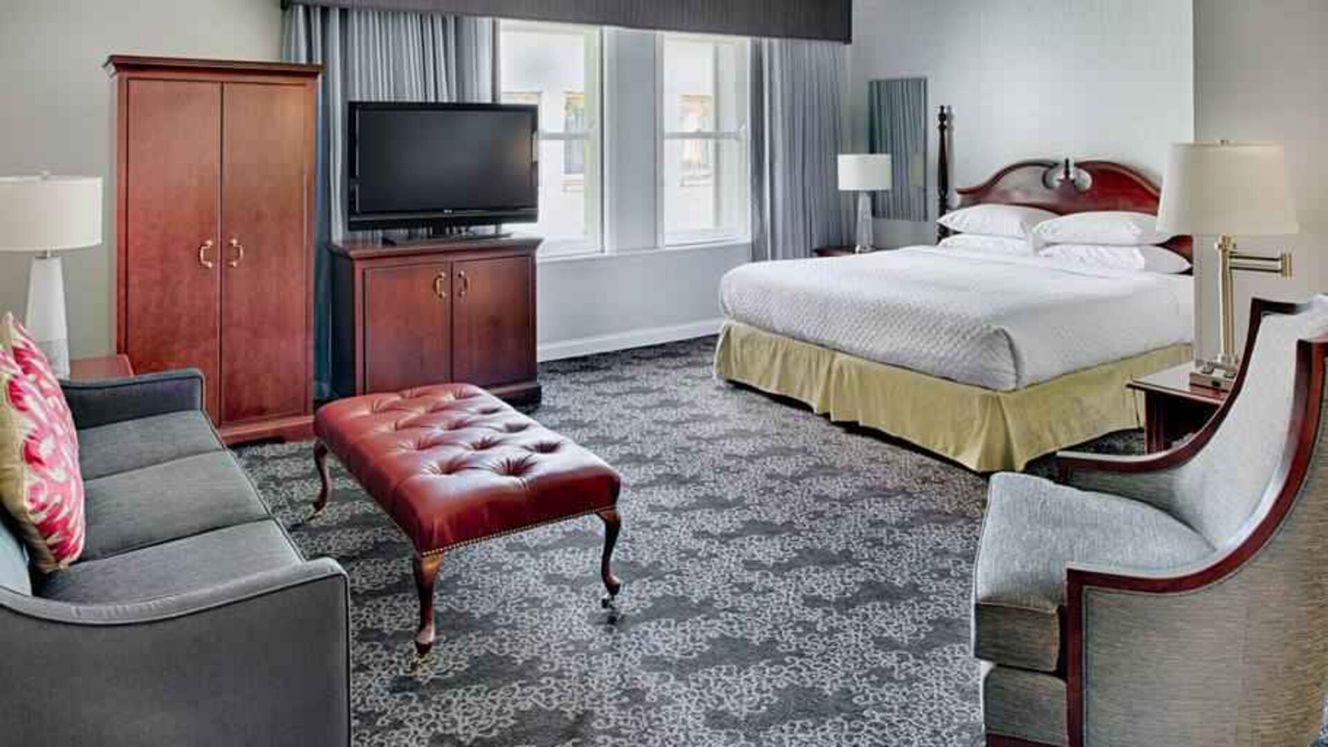 Spacious king studio with sofa and window at the Embassy Suites by Hilton Portland-Downtown.