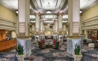 Elegant lobby area with tables and chairs perfect as workspace at the Embassy Suites by Hilton Portland-Downtown.