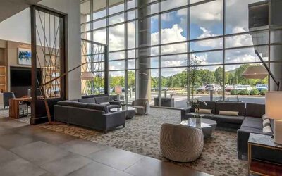 Beautiful lobby area with large windows and lounges perfect as workspace at the Hilton Franklin Cool Springs.
