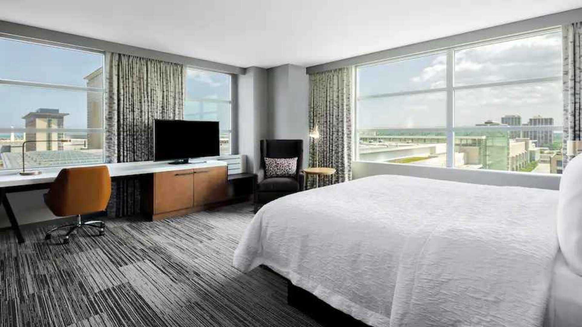 King suite with desk and large windows at the Hilton Garden Inn Chicago McCormick Place.