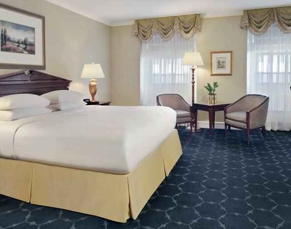 King size bed, sofa and desk in a hotel room at The Drake.