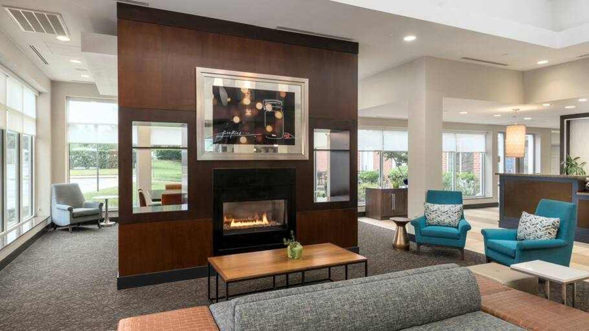 Beautiful workspace by the fireplace in a hotel lobby at the Hilton Garden Inn Silver Spring White Oak.