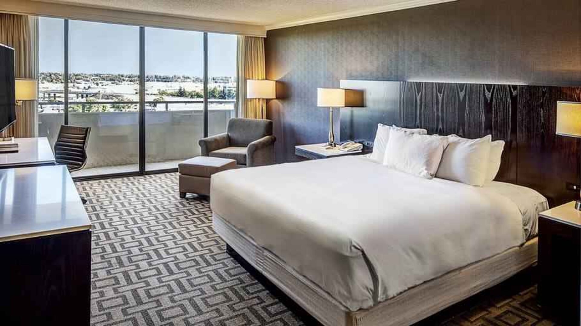 Comfortable king suite with city view at the Hilton Sacramento-Arden West.