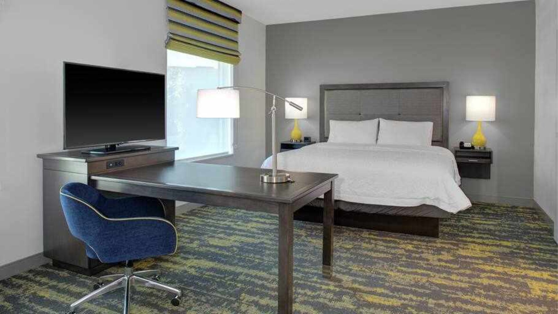 Working station in a king bedroom at the Hampton Inn & Suites by Hilton-Irvine/Orange County Airport.