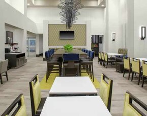 Comfortable dining area perfect as workspace at the Hampton Inn & Suites by Hilton-Irvine/Orange County Airport.
