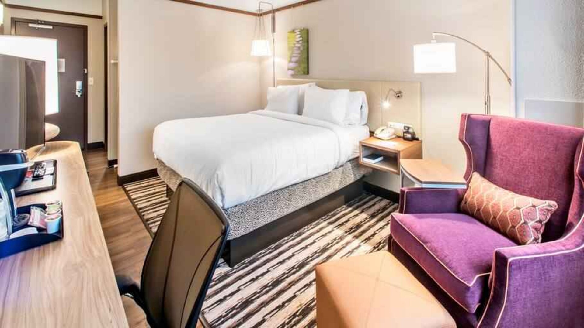 Desk, sofa and king size bed in a king bedroom at the Hilton Garden Inn Minneapolis Airport Mall of America.