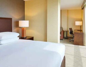 King suite with windows and working station at the Hilton San Antonio-Airport.