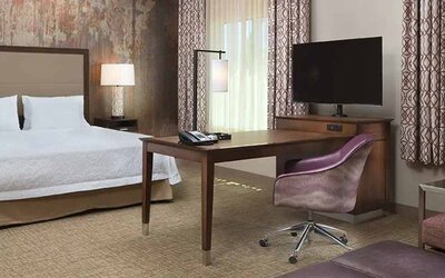 Spacious king suite with work area at Hampton Inn & Suites Murrieta Temecula.