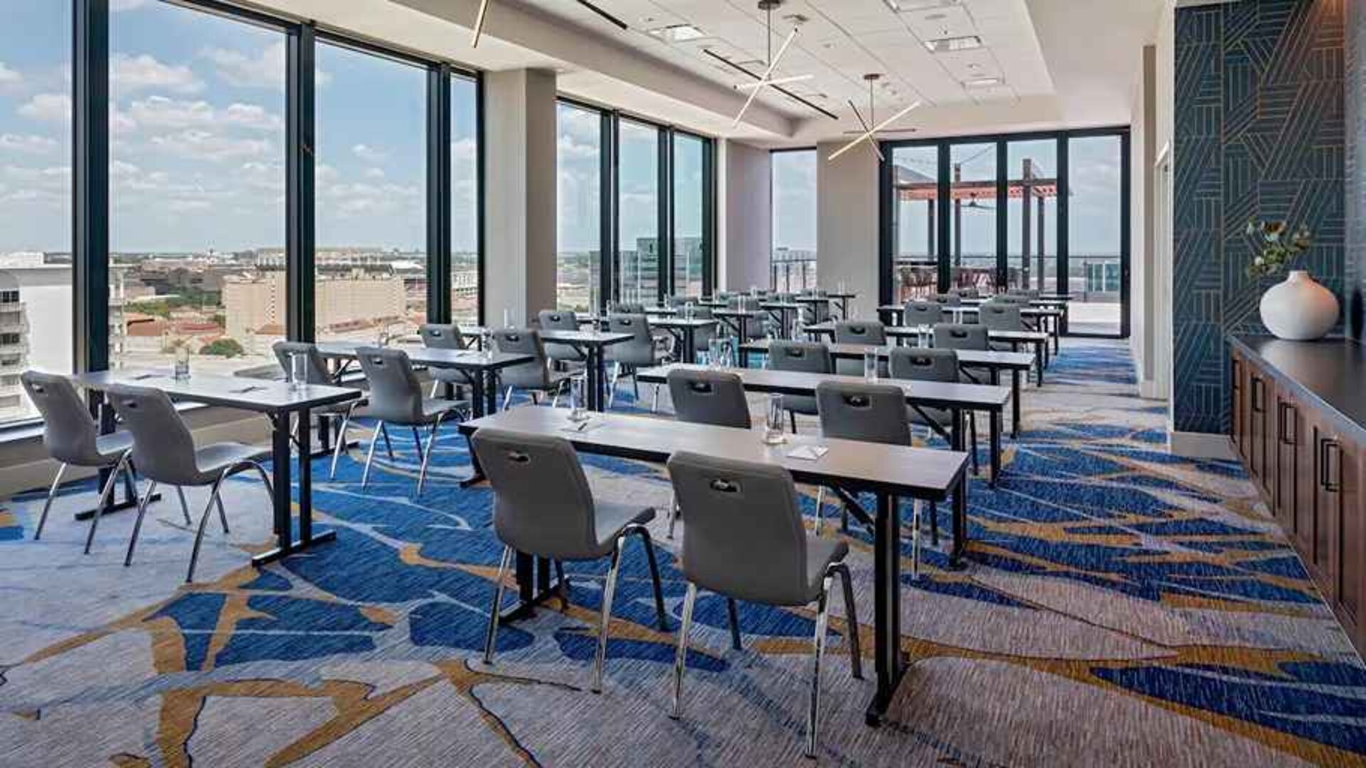 Professional conference room with a lot of natural light and city views at Hilton Garden Inn Austin University.
