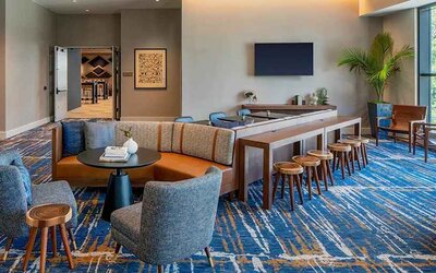 A coworking space with lots of natural light at Hilton Garden Inn Austin University.