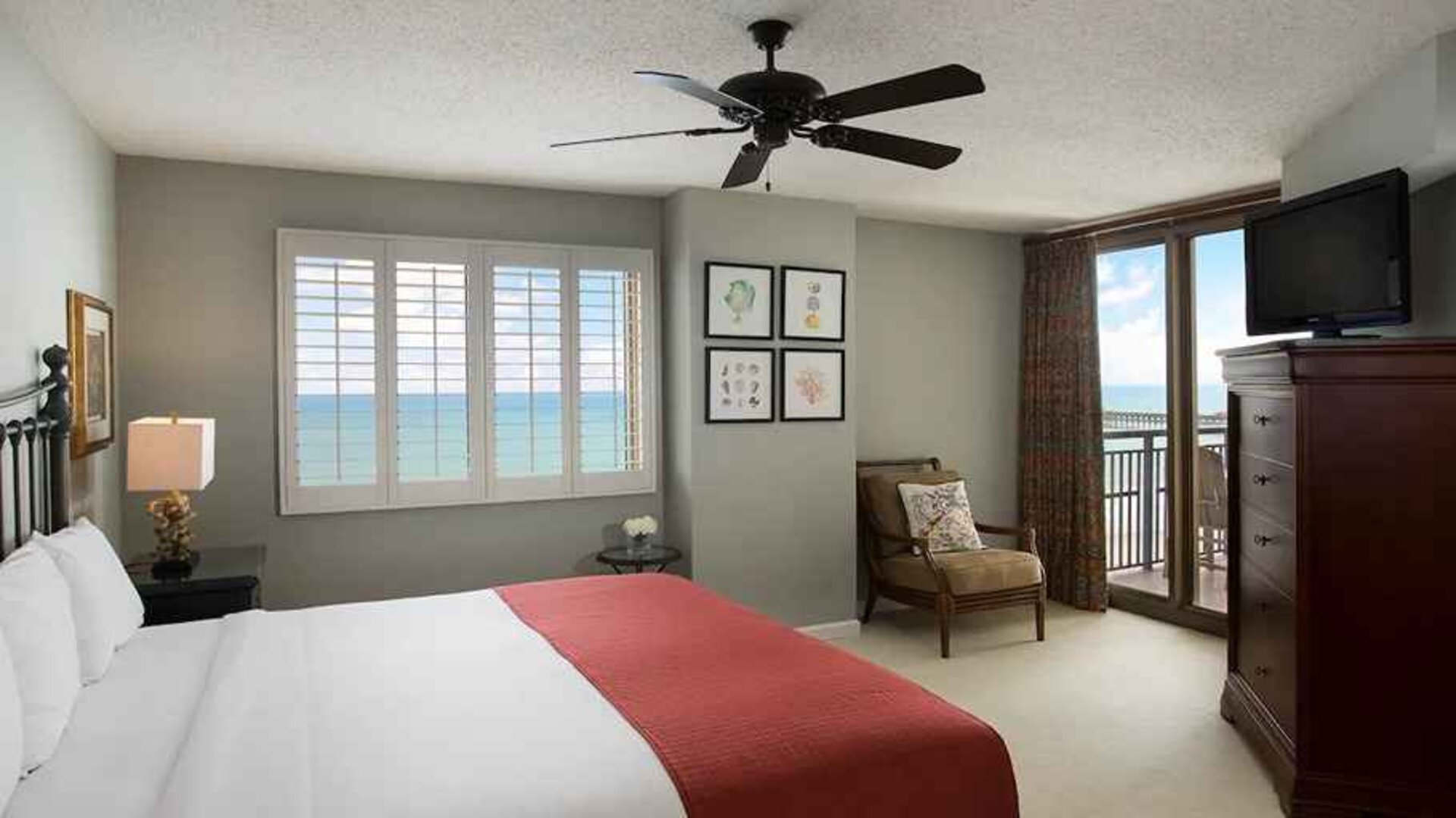 king room with fan, TV, and sea views at Kingston Plantation Condos.