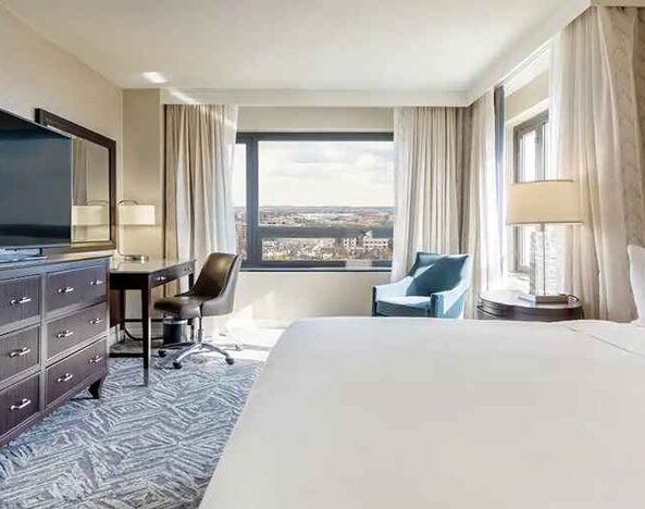 beautiful king room with work desk, TV, and natural light at Washington Hilton.